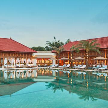 a pool with lounge chairs and palm trees