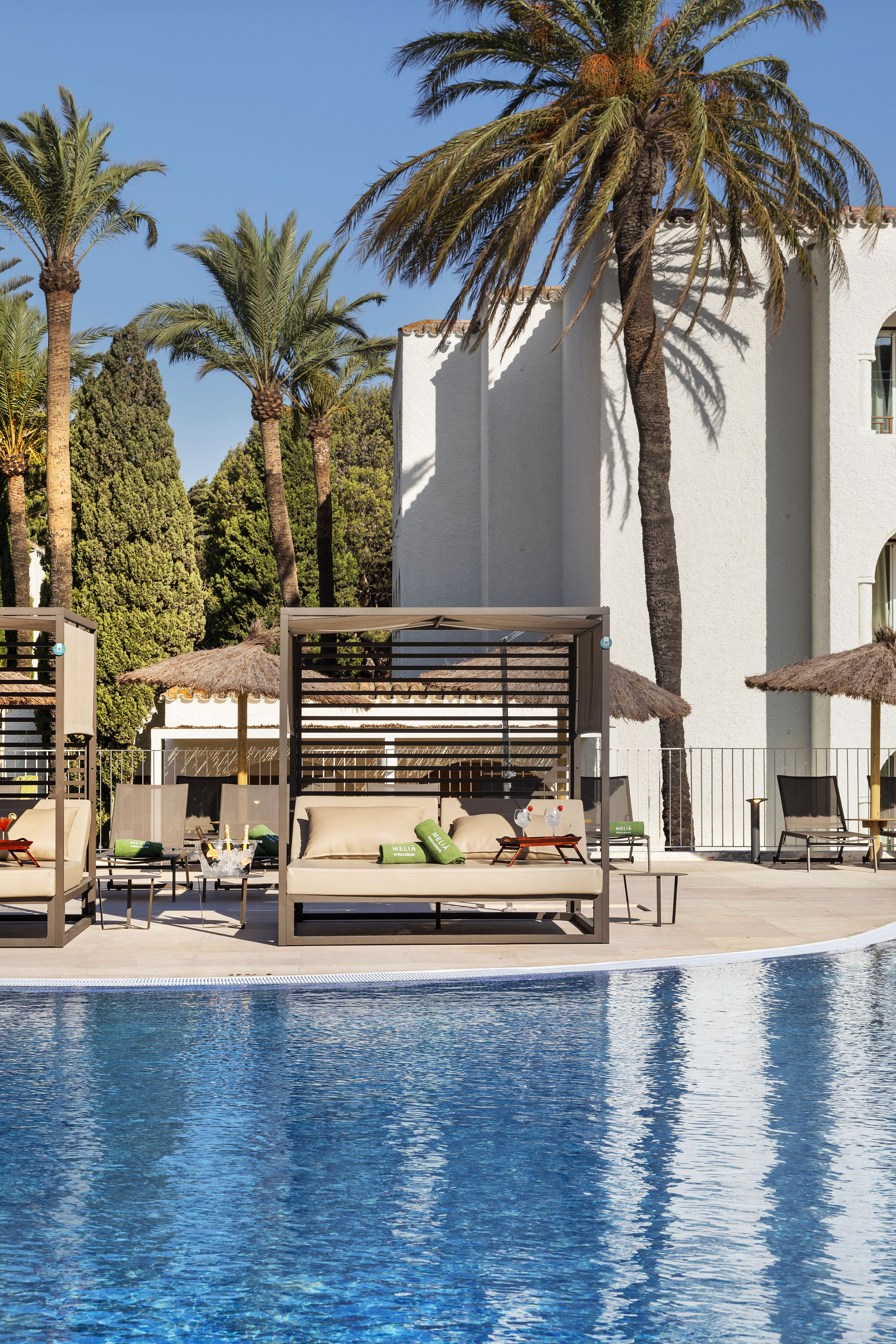 a pool with lounge chairs and umbrellas