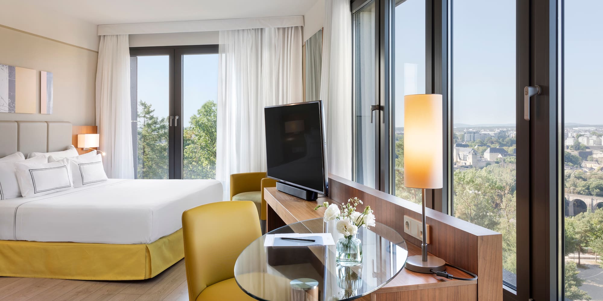 a room with a bed and a television