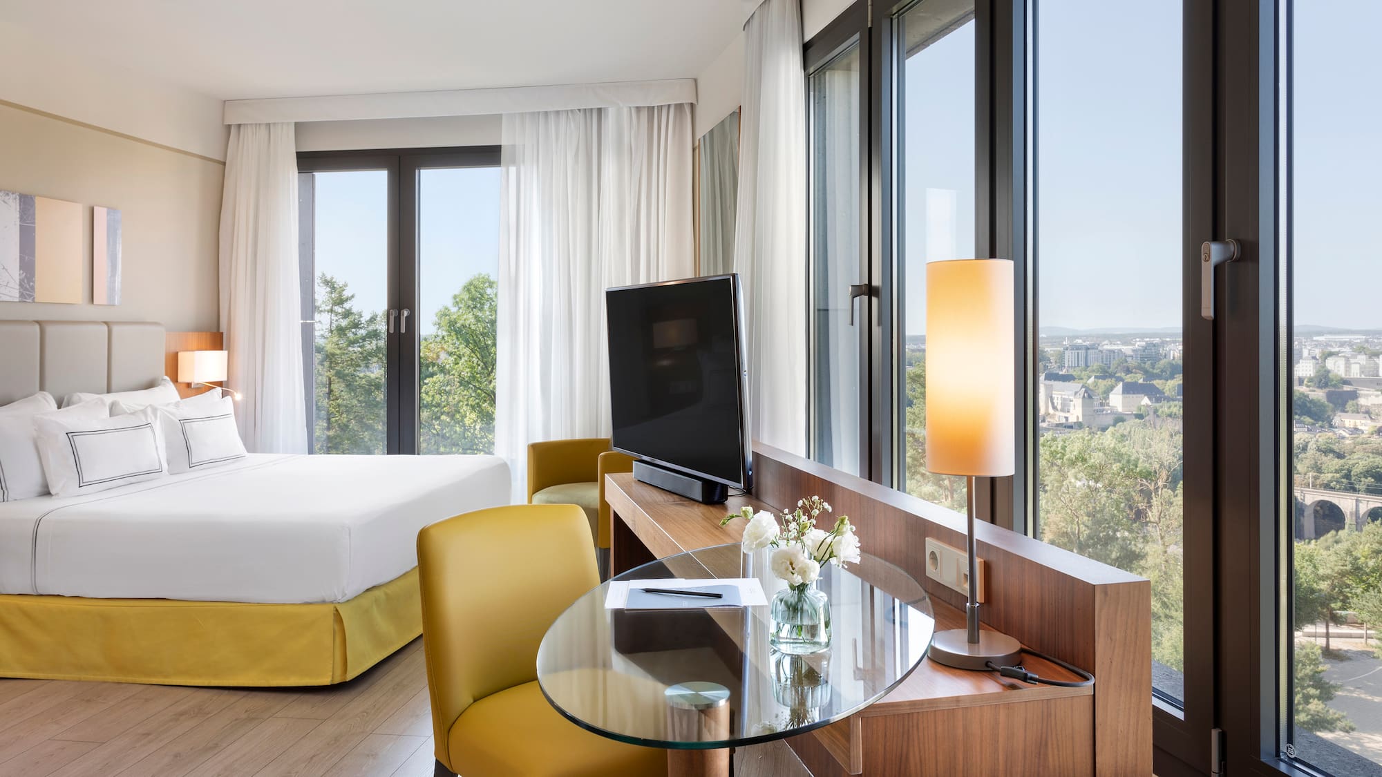 a room with a bed and a television