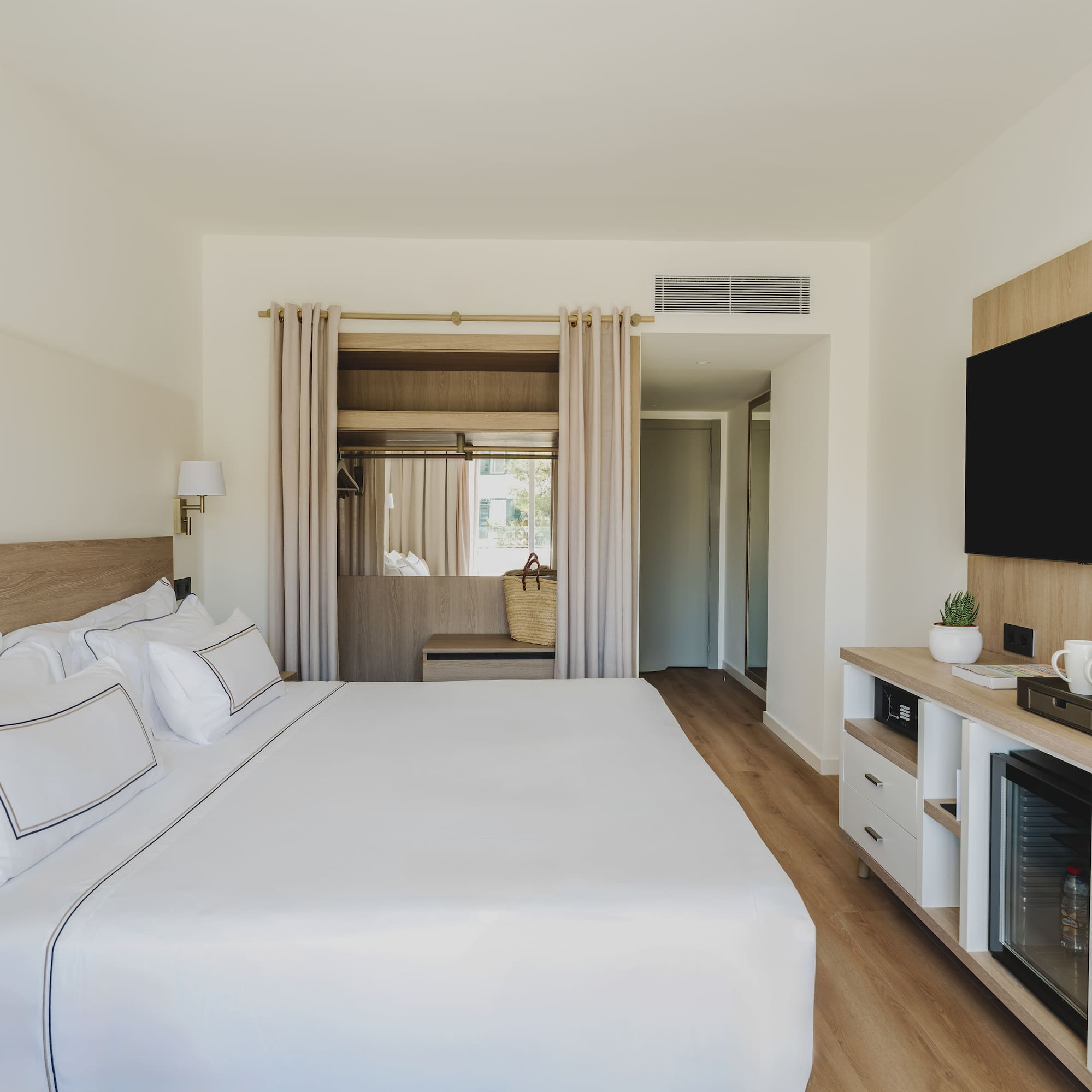 a room with a bed and a television
