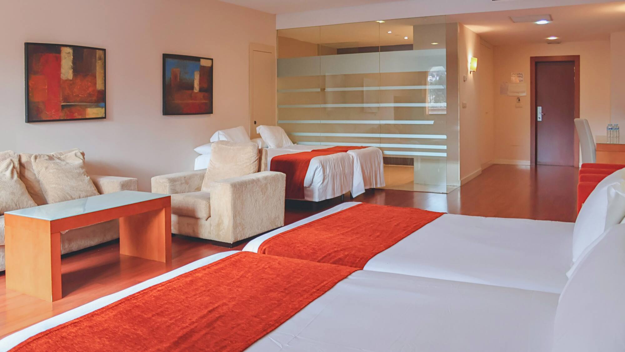 a room with two beds and a glass wall