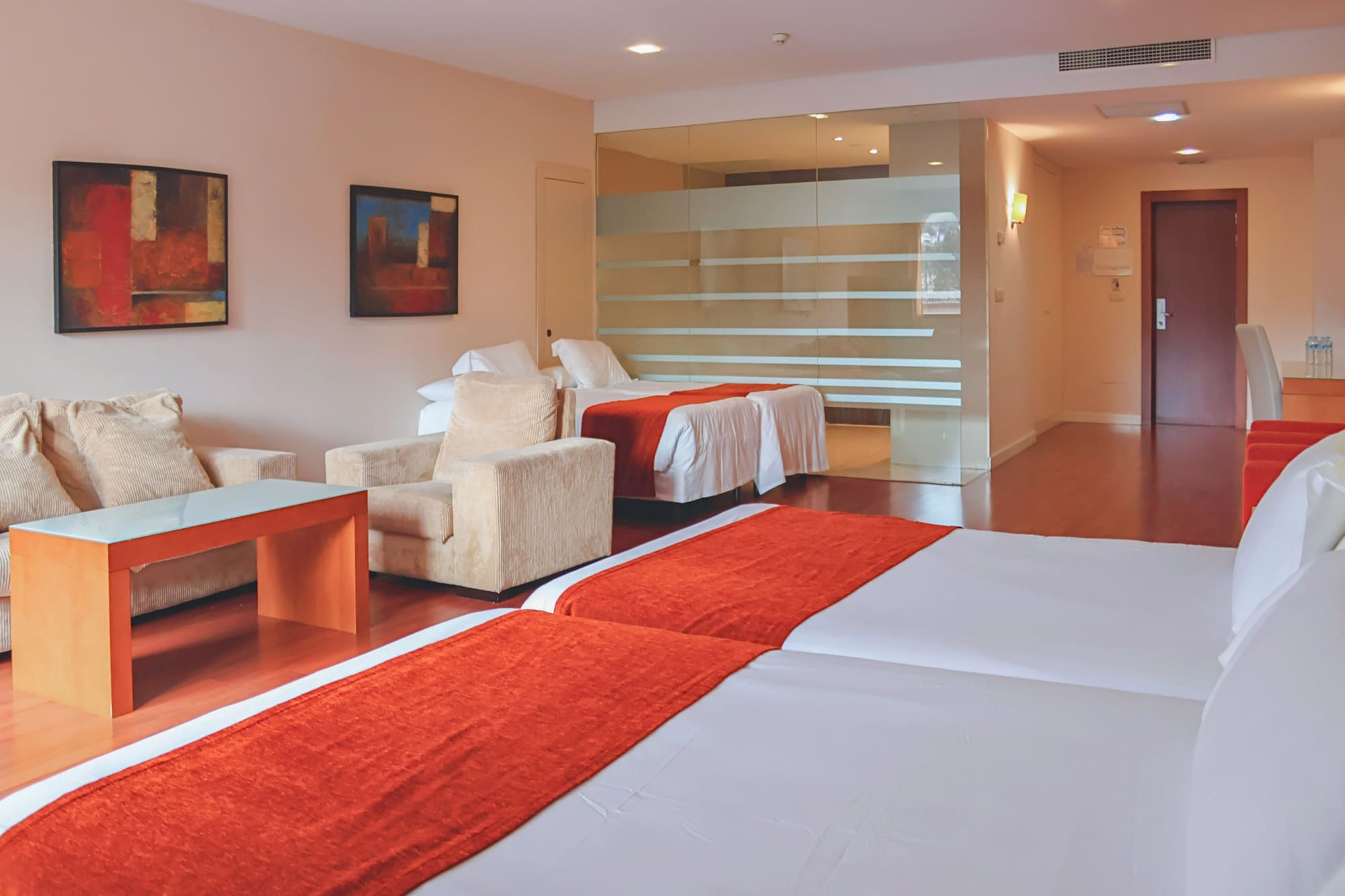 a room with two beds and a glass wall