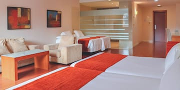 a room with two beds and a glass wall