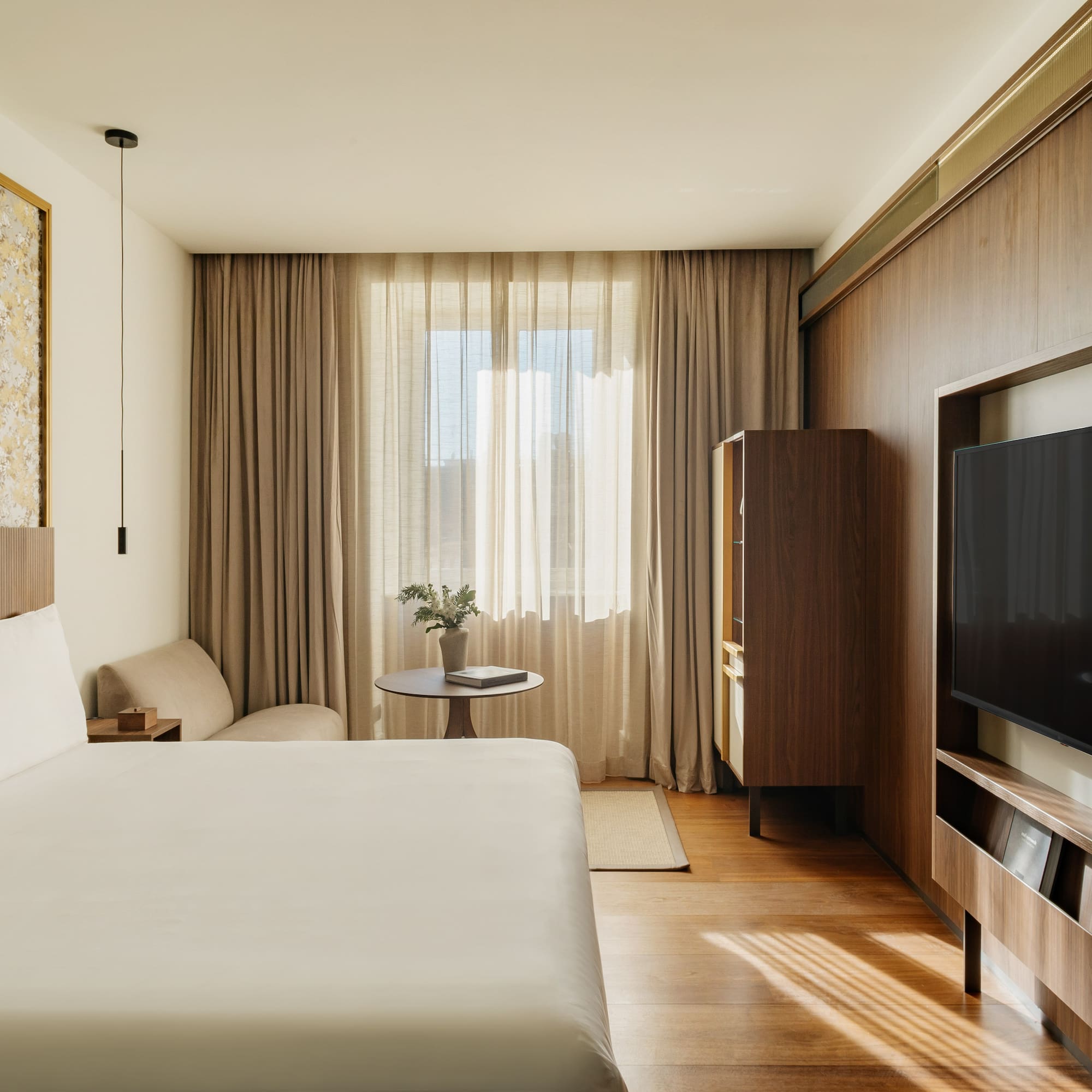 a room with a bed and a television