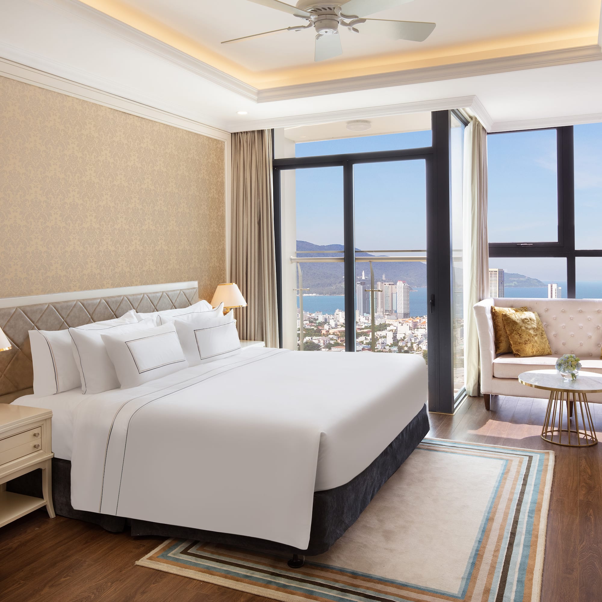 a bedroom with a large window overlooking a city