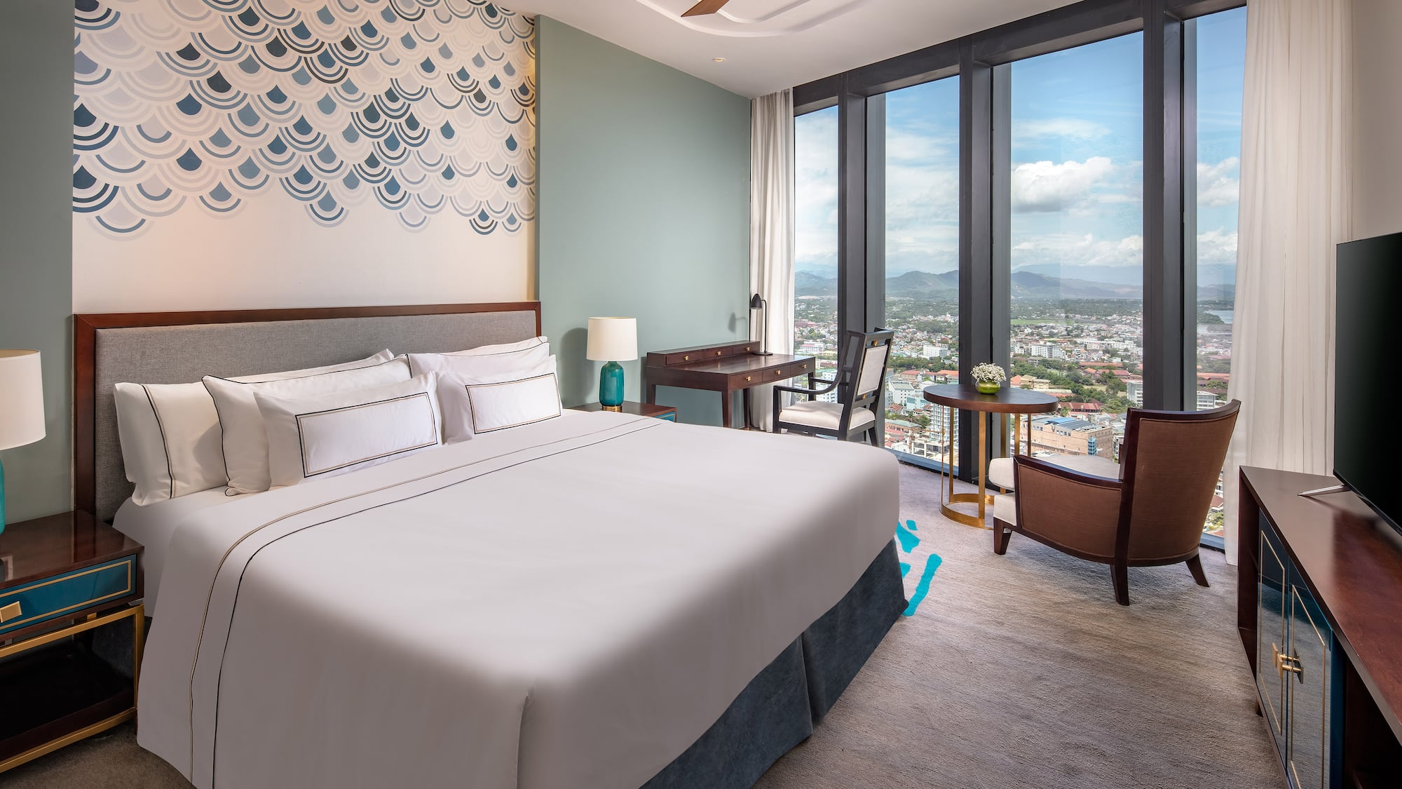 a bedroom with a large window and a large bed