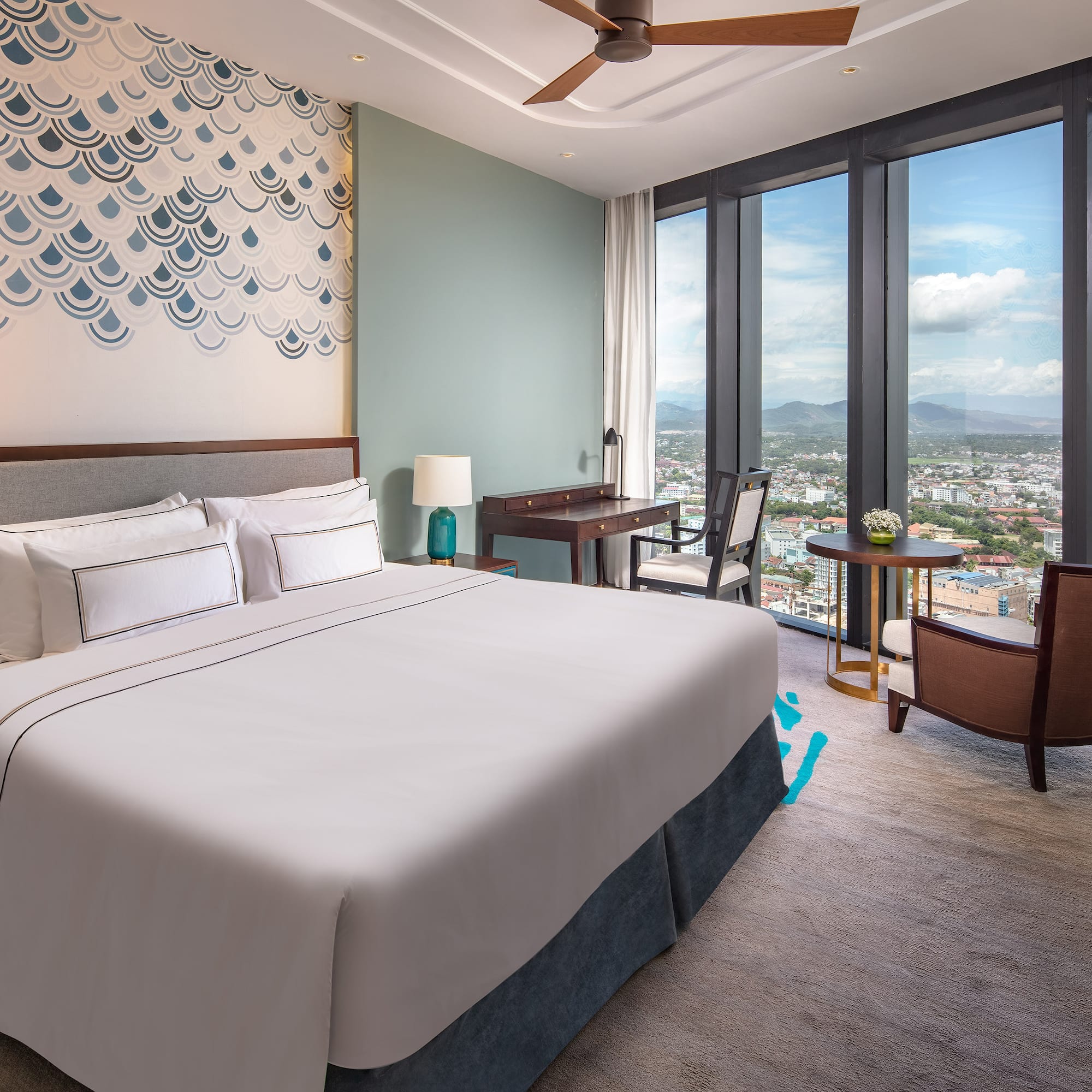 a bedroom with a large window and a large bed