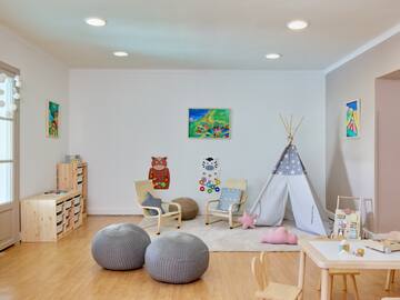 a room with a teepee and chairs
