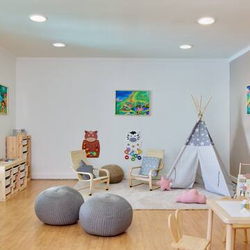 a room with a teepee and chairs