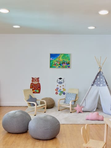 a room with a teepee and chairs