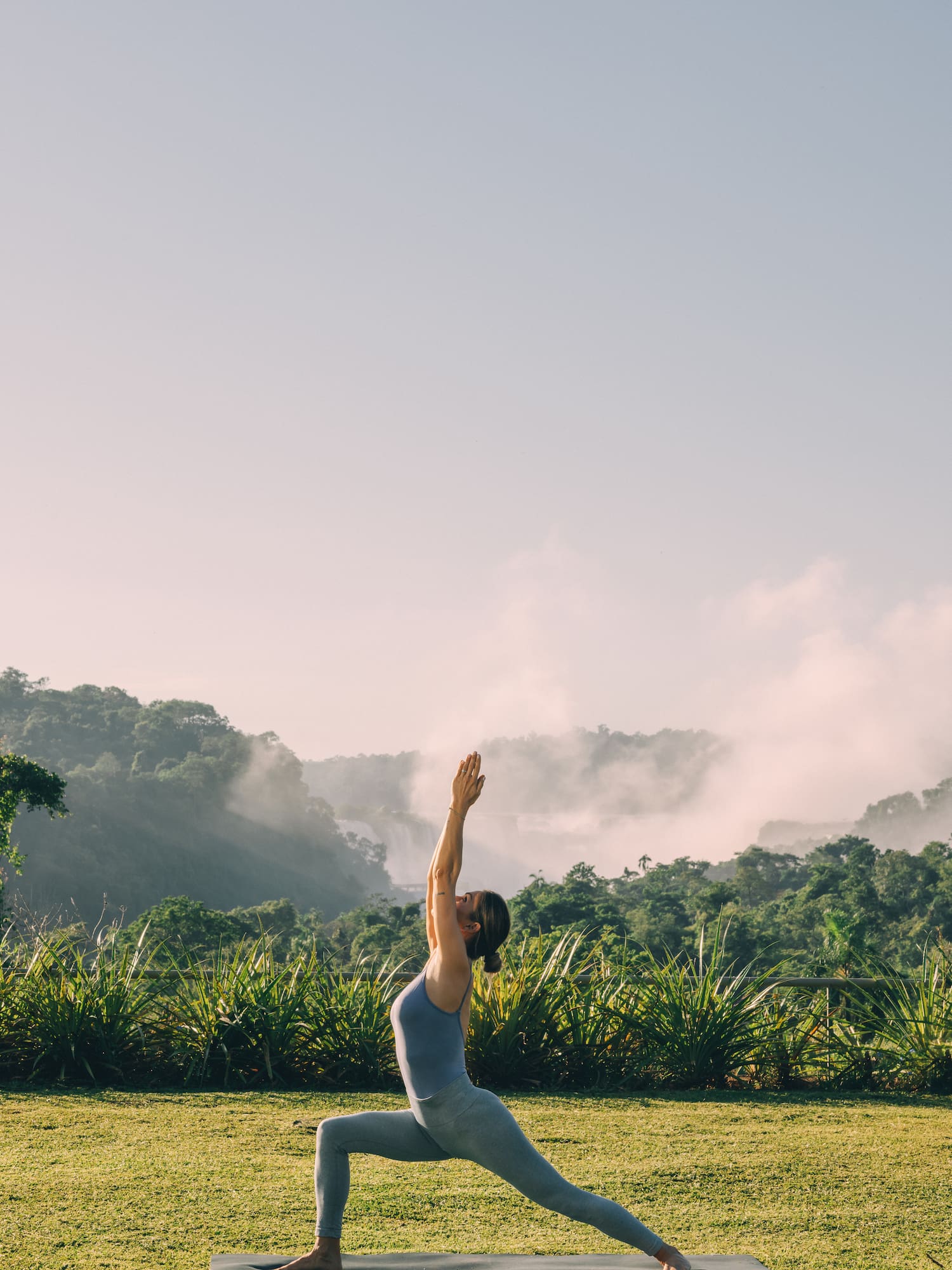 a woman doing yoga in the grass
