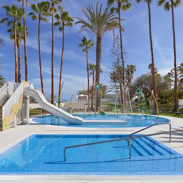 a pool with a slide and a slide in it