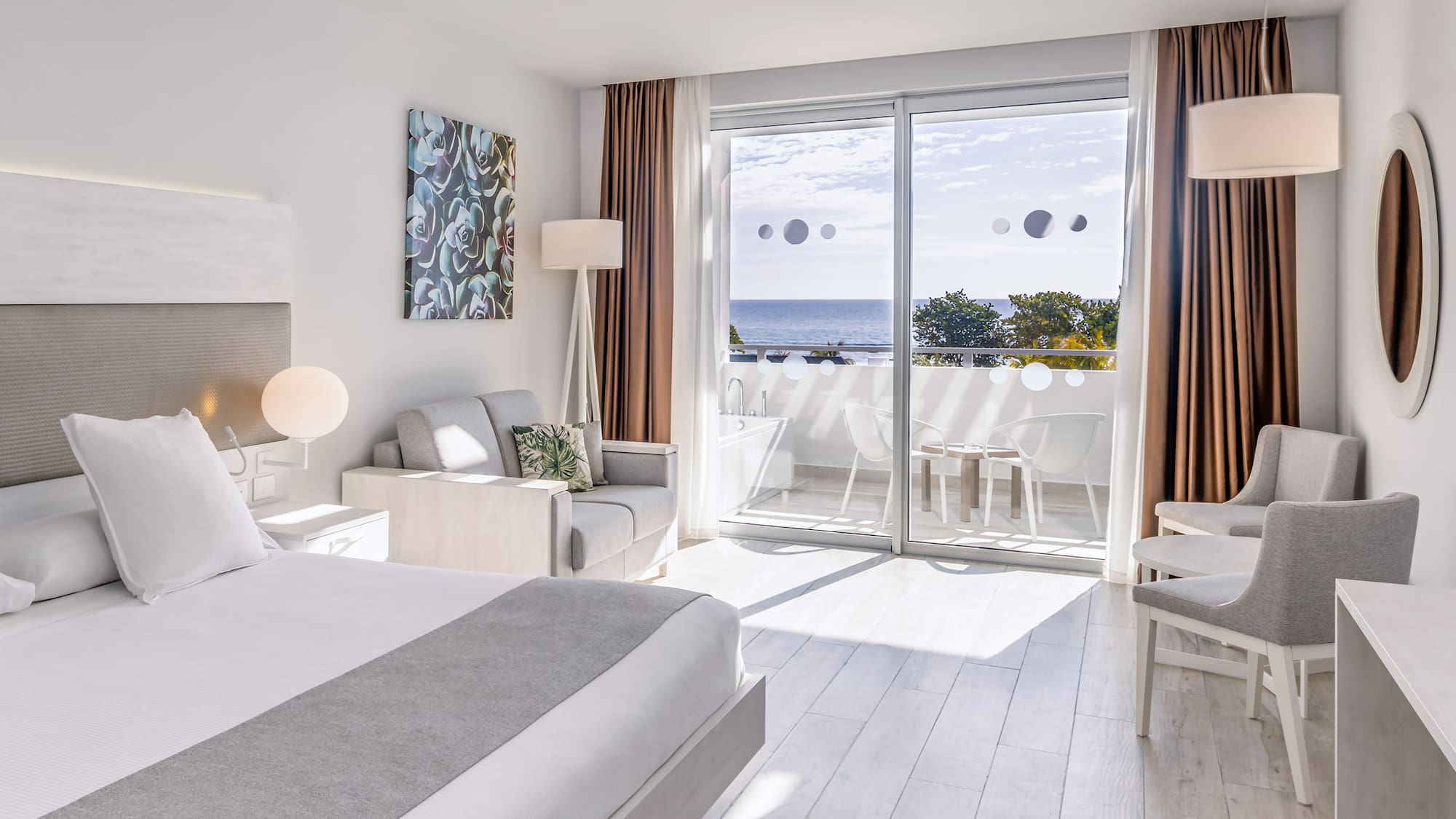 a bedroom with a view of the ocean