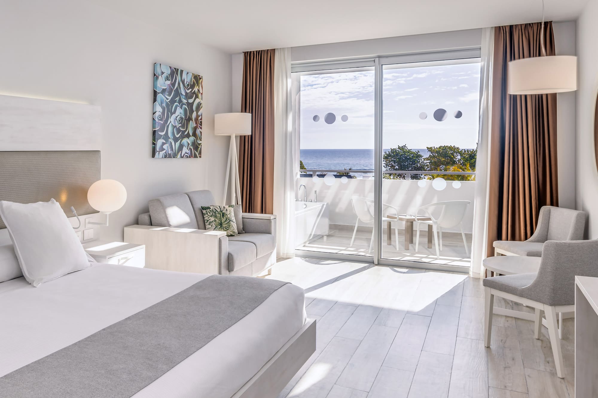 a bedroom with a view of the ocean