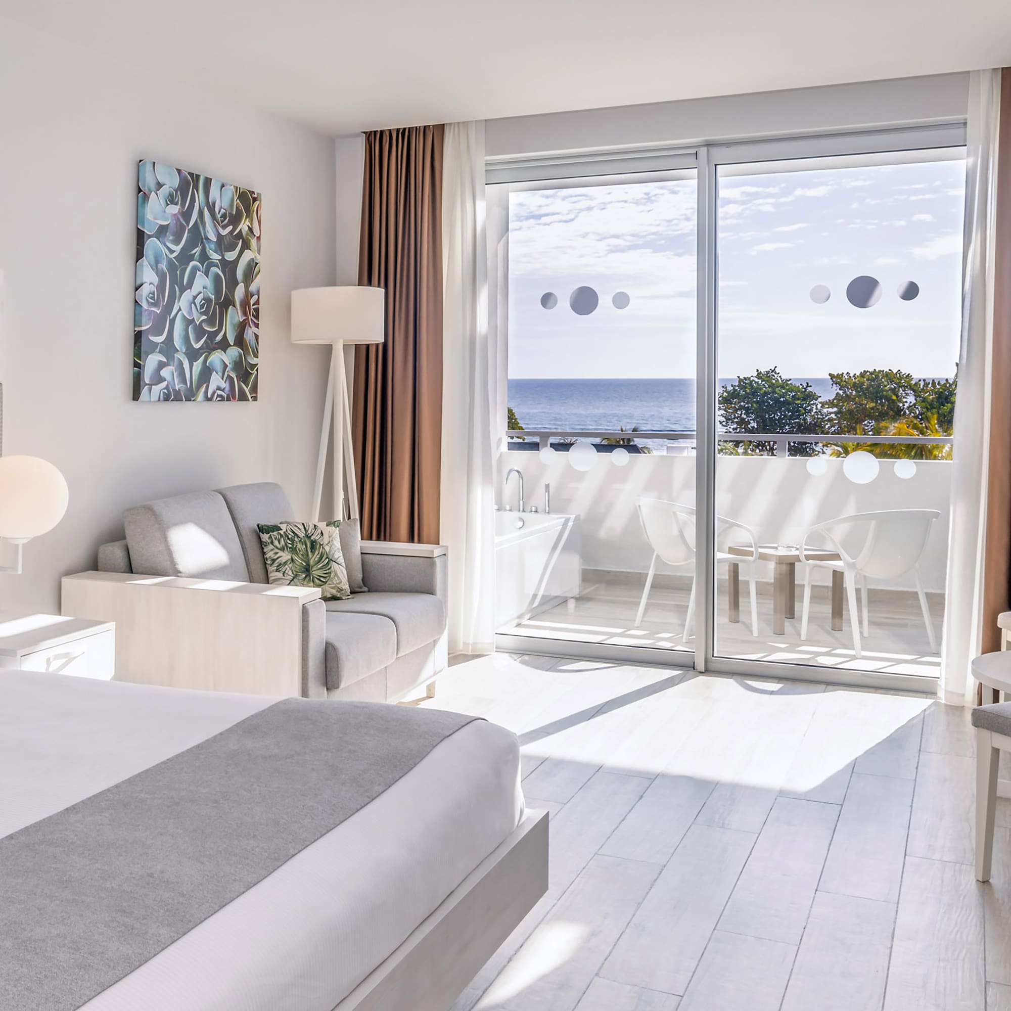 a bedroom with a view of the ocean