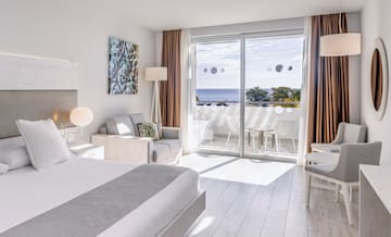 a bedroom with a view of the ocean