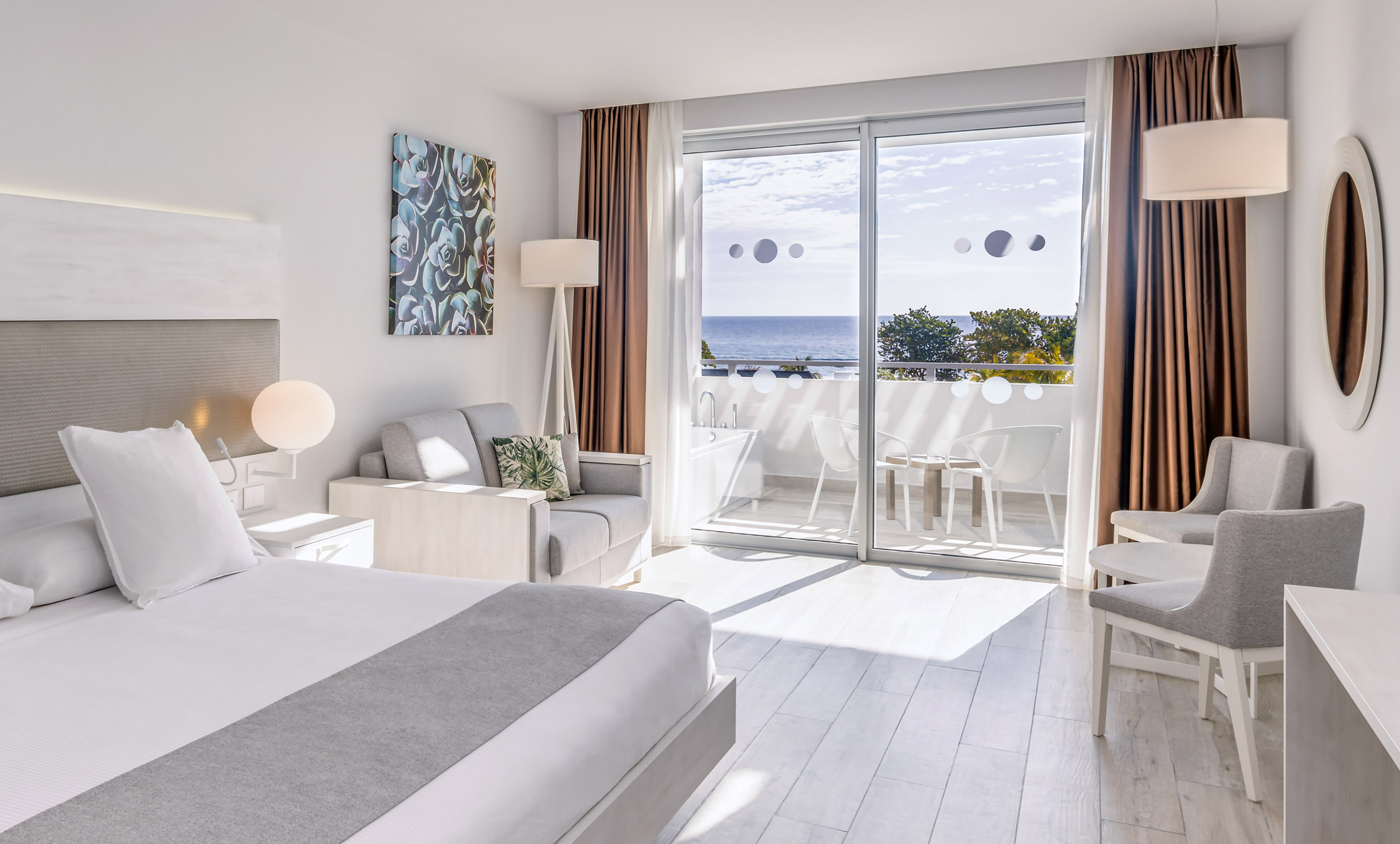 a bedroom with a view of the ocean