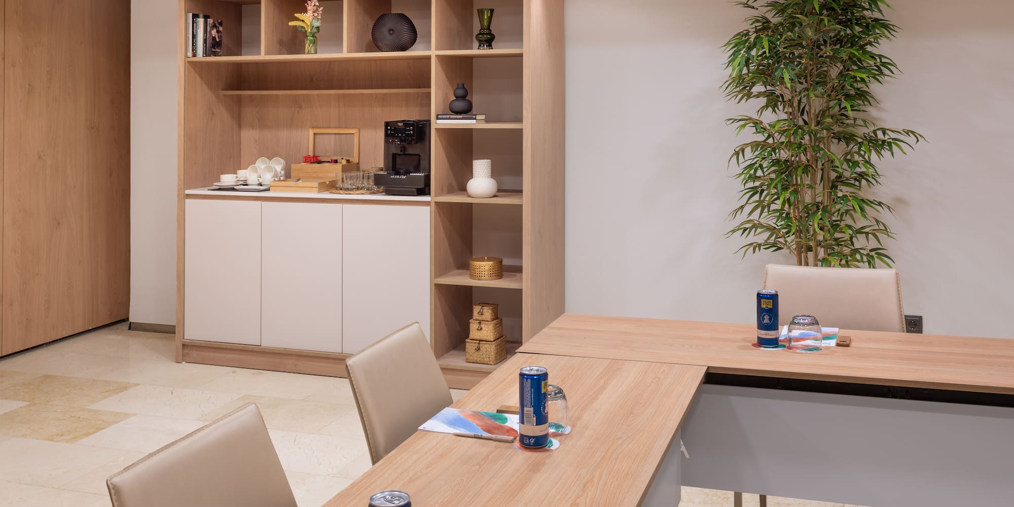 a room with a table and chairs and a plant