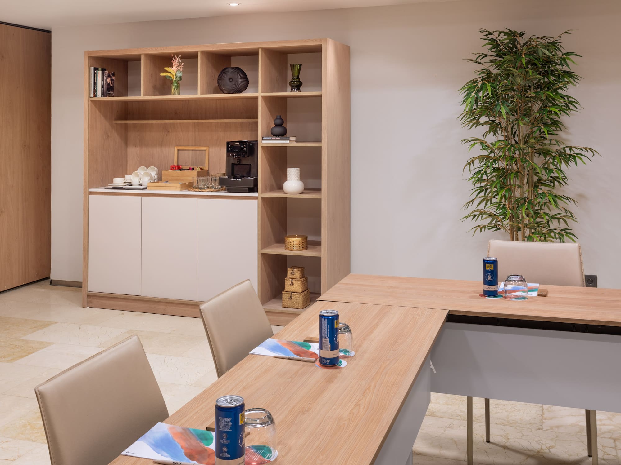 a room with a table and chairs and a plant