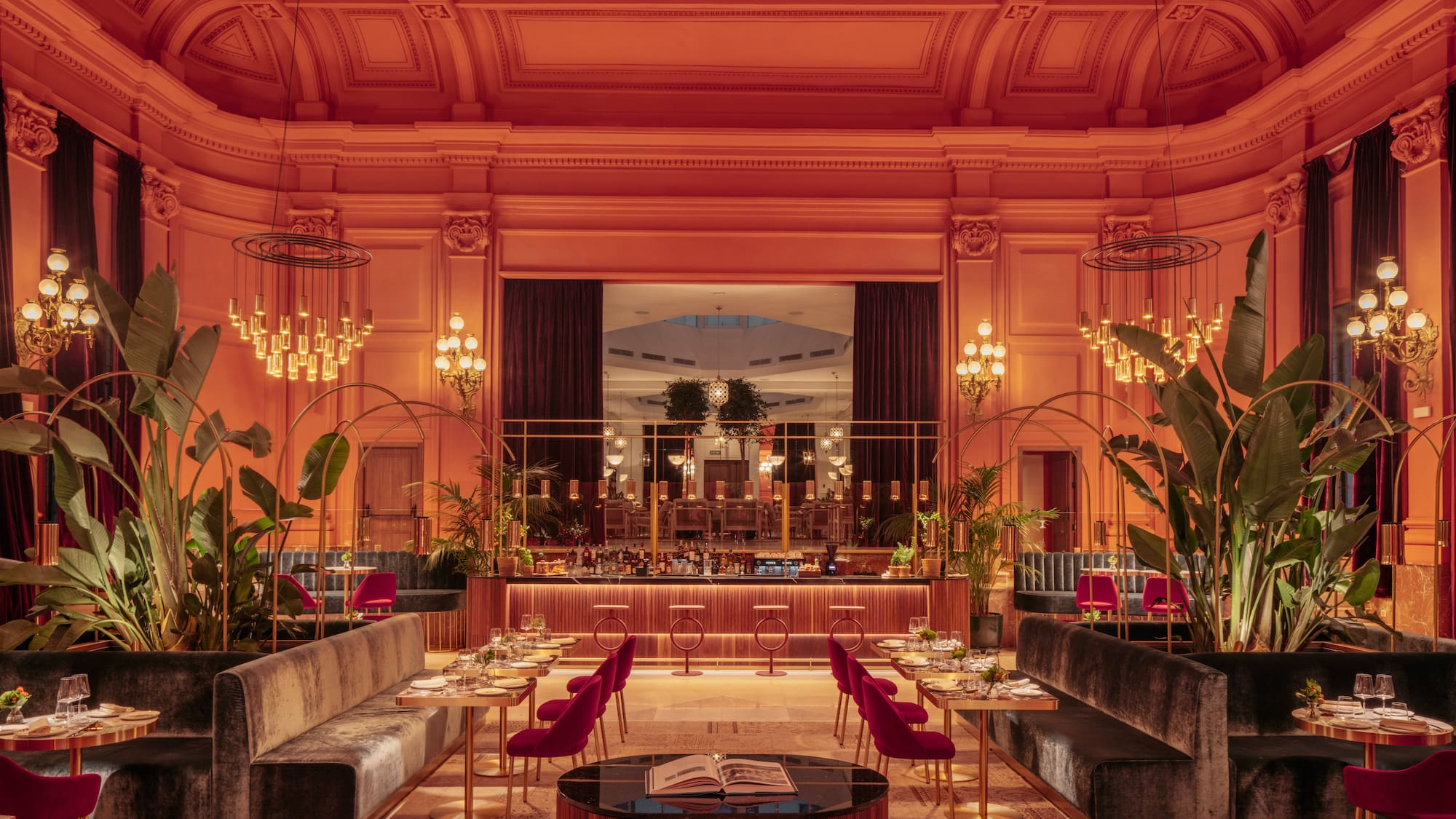 a room with tables and chairs and chandeliers
