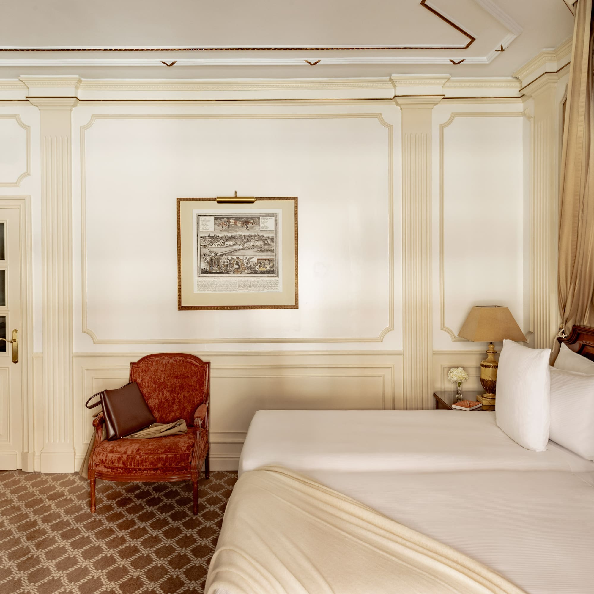 a room with two beds and a chair