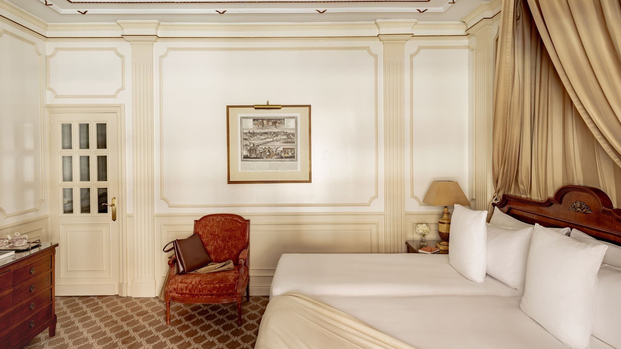 a room with two beds and a chair