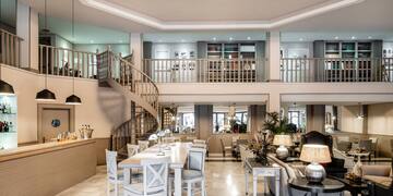 a room with a spiral staircase and a large table and chairs