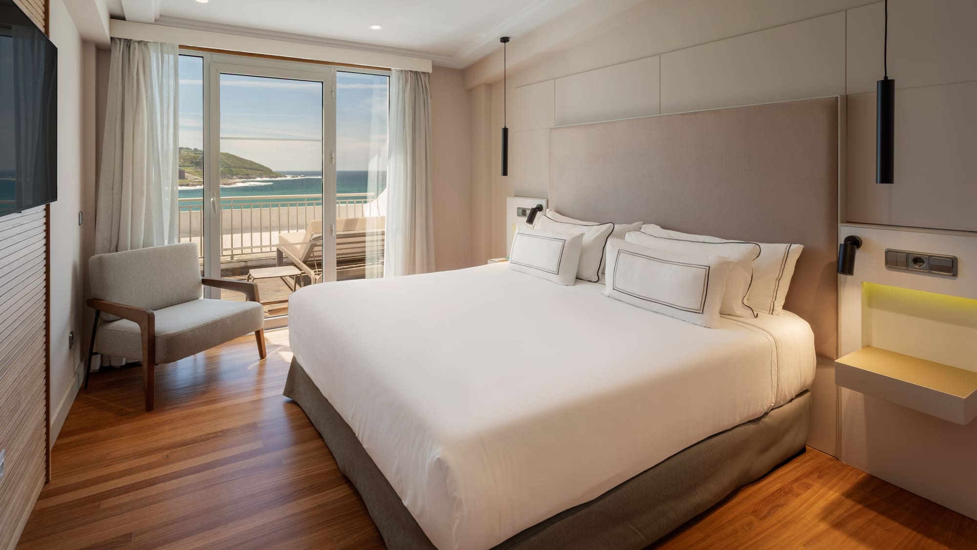 a bedroom with a large bed and a chair