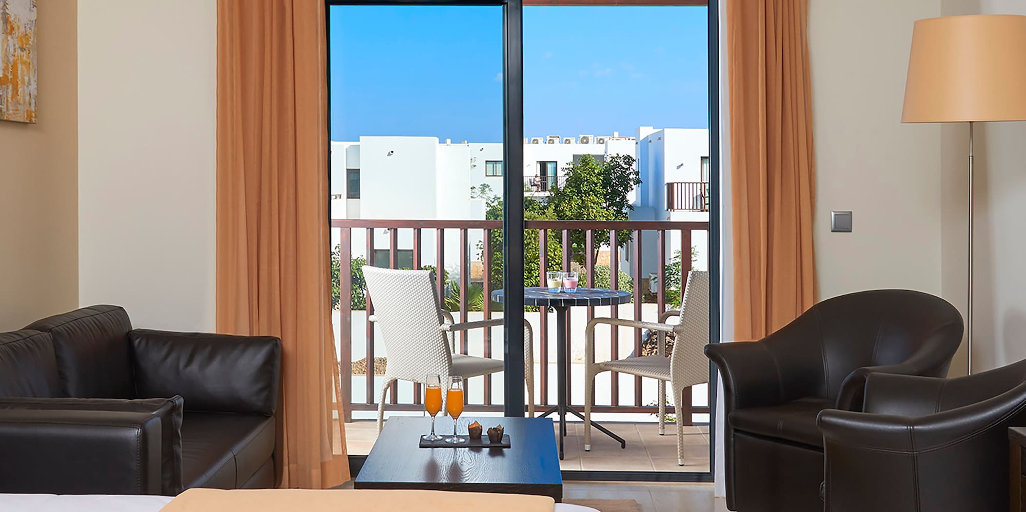 a room with a bed and chairs and a table