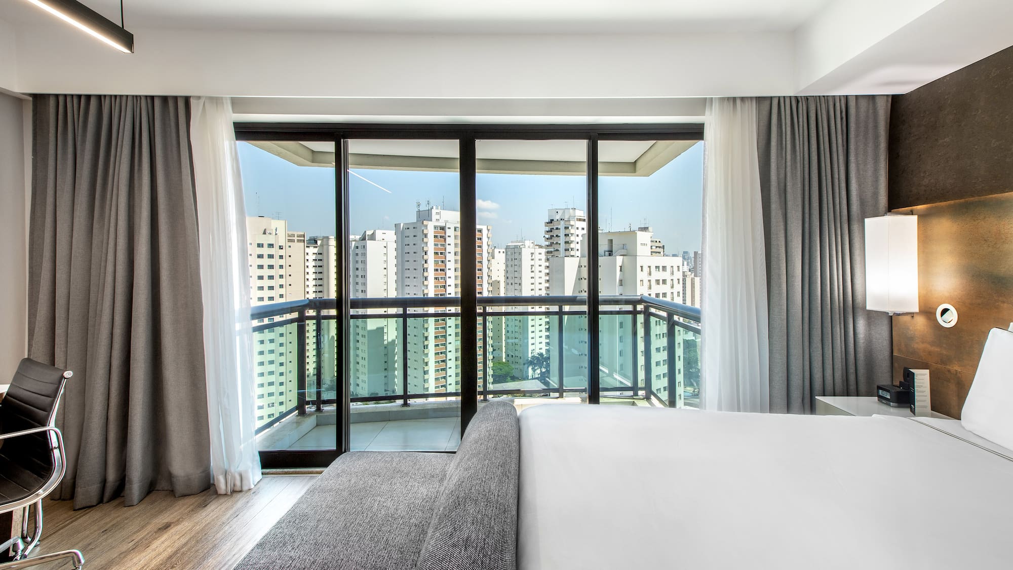 a bedroom with a large window and a couch