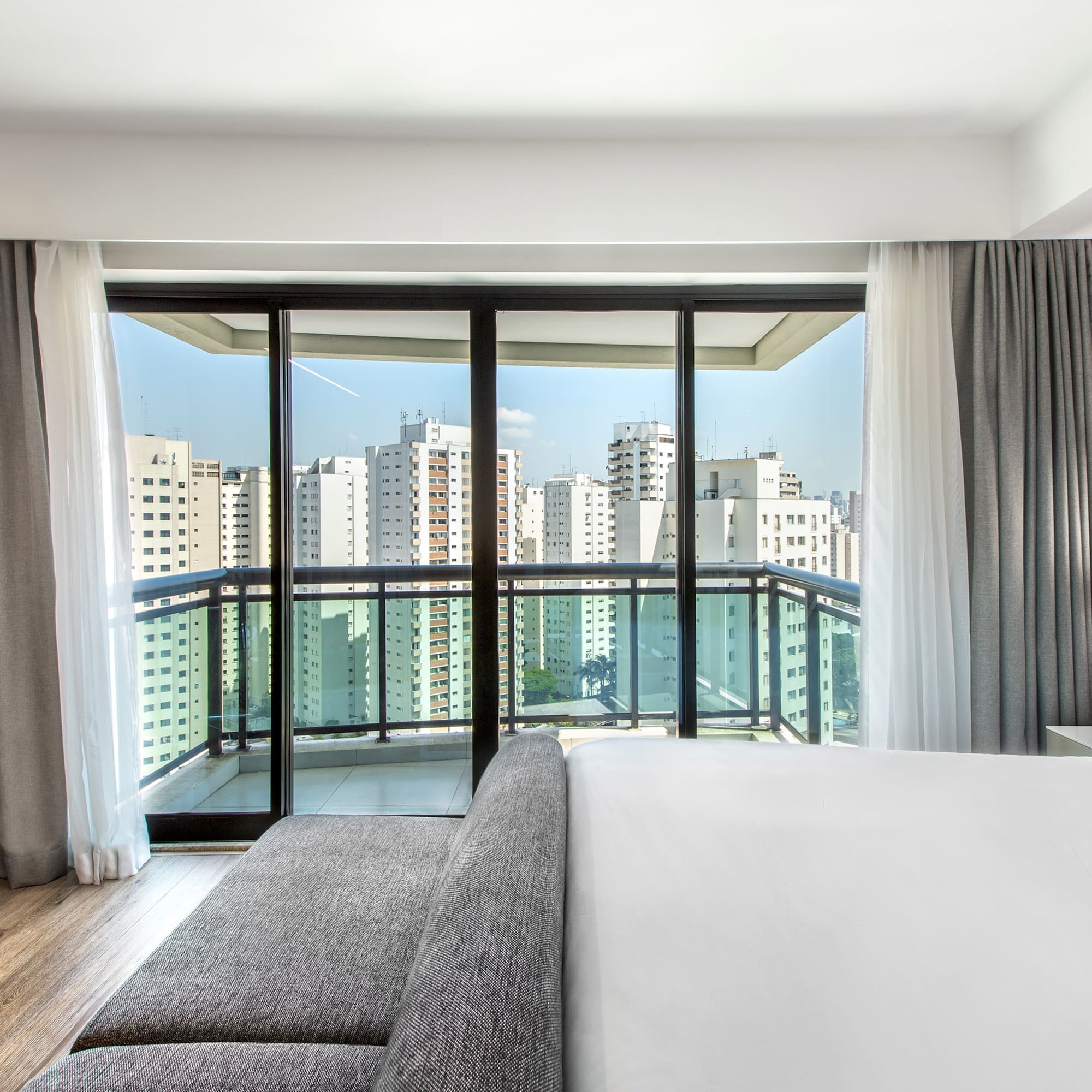 a bedroom with a large window and a couch