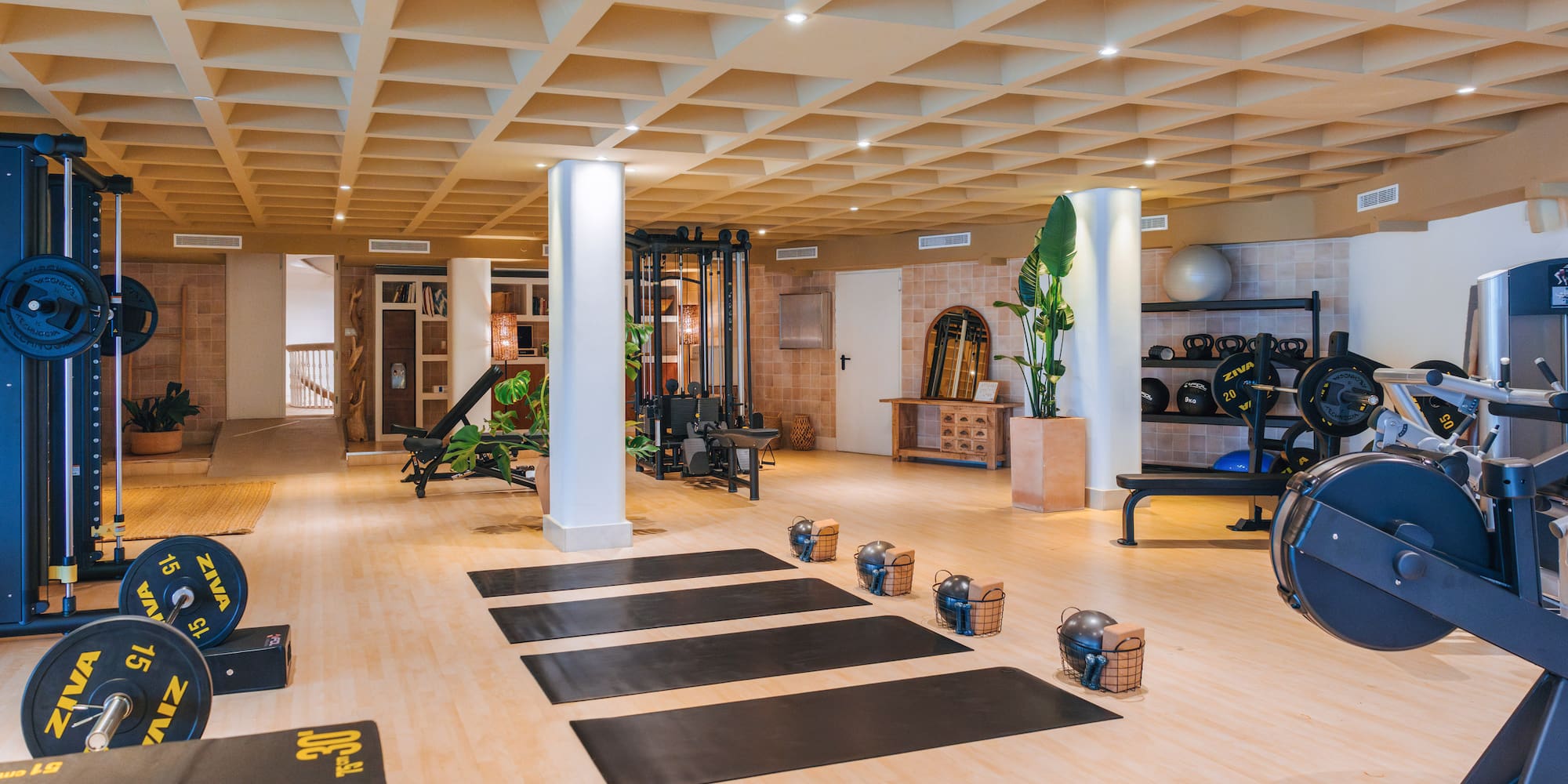 a large room with exercise mats and equipment