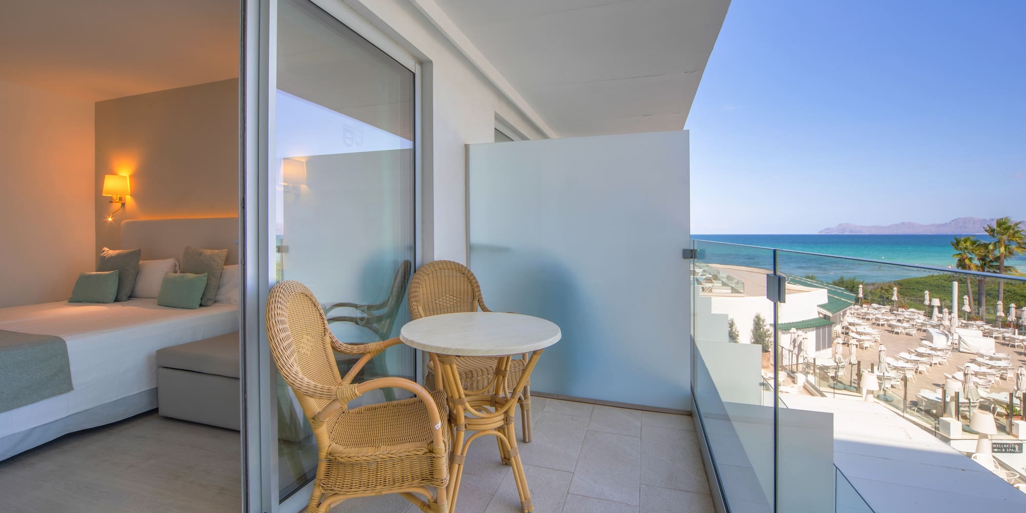 a balcony with chairs and a table
