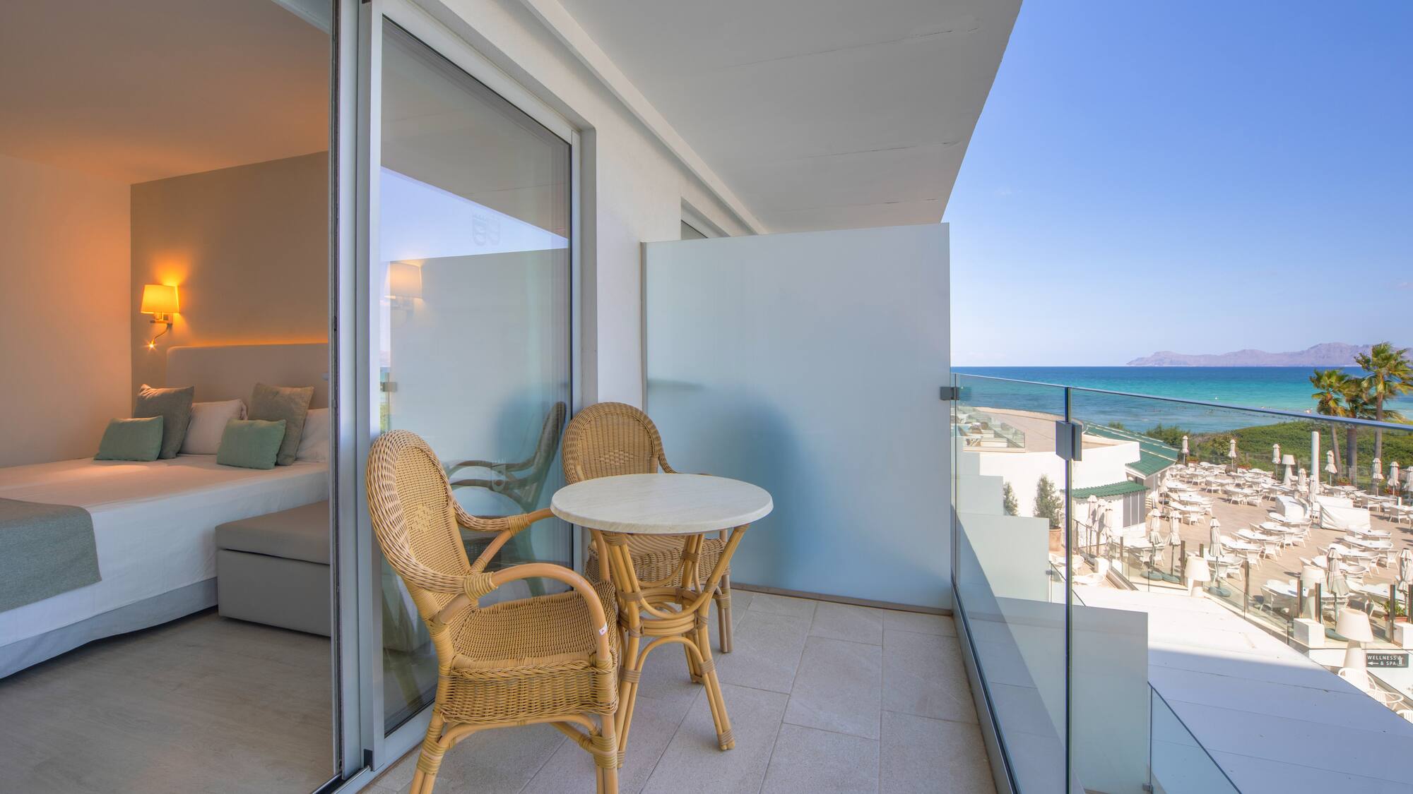 a balcony with chairs and a table