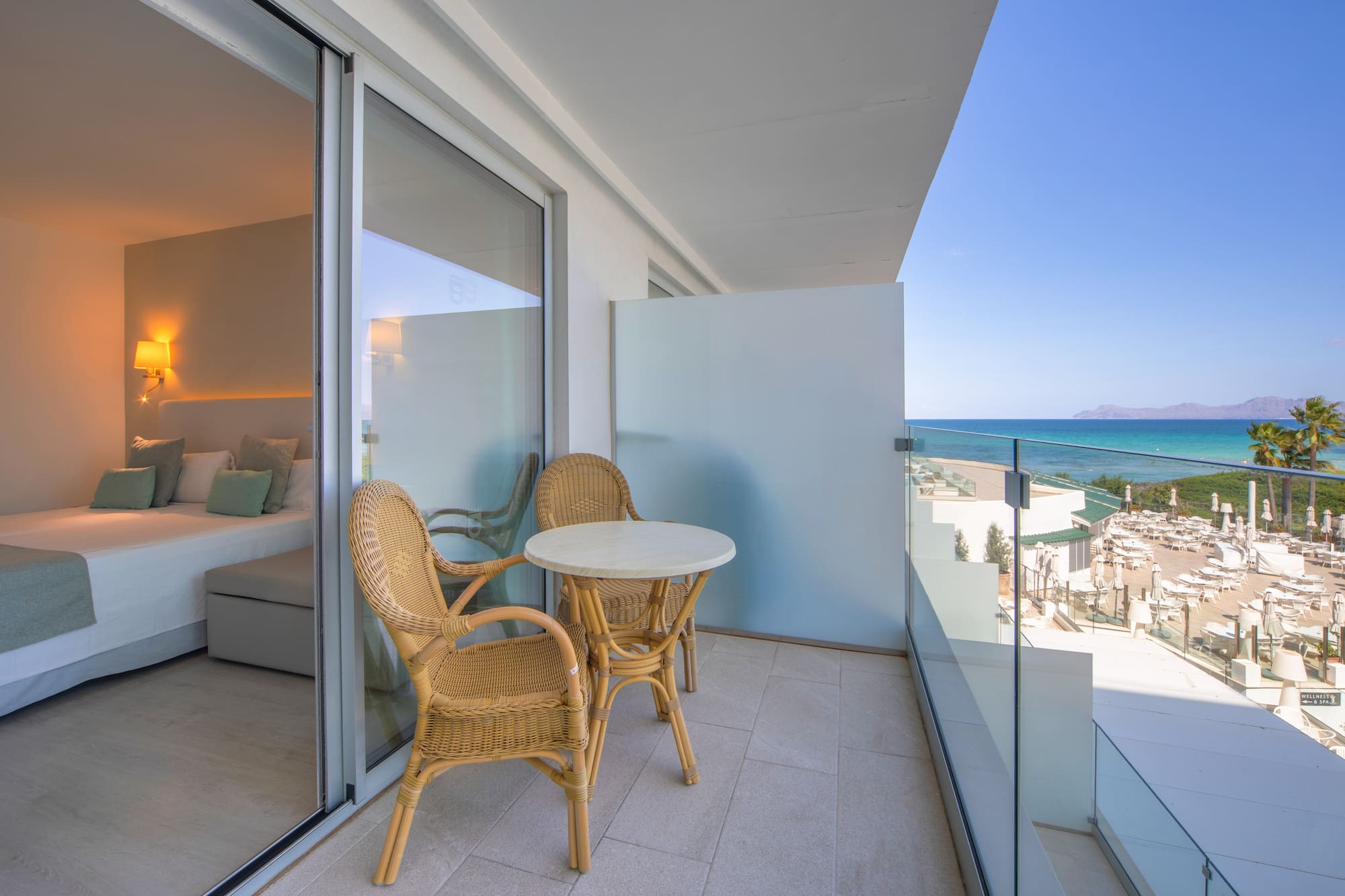 a balcony with chairs and a table