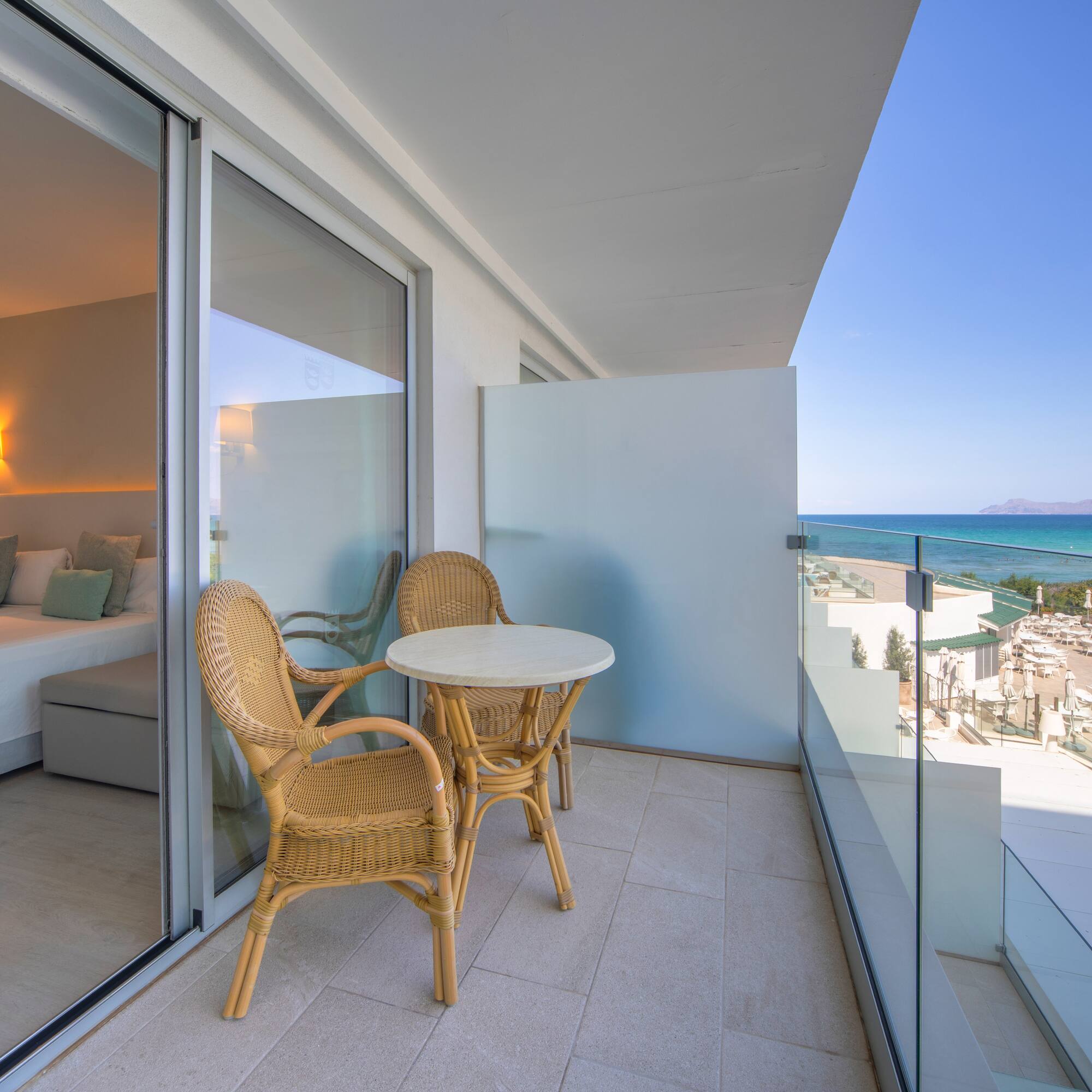 a balcony with chairs and a table
