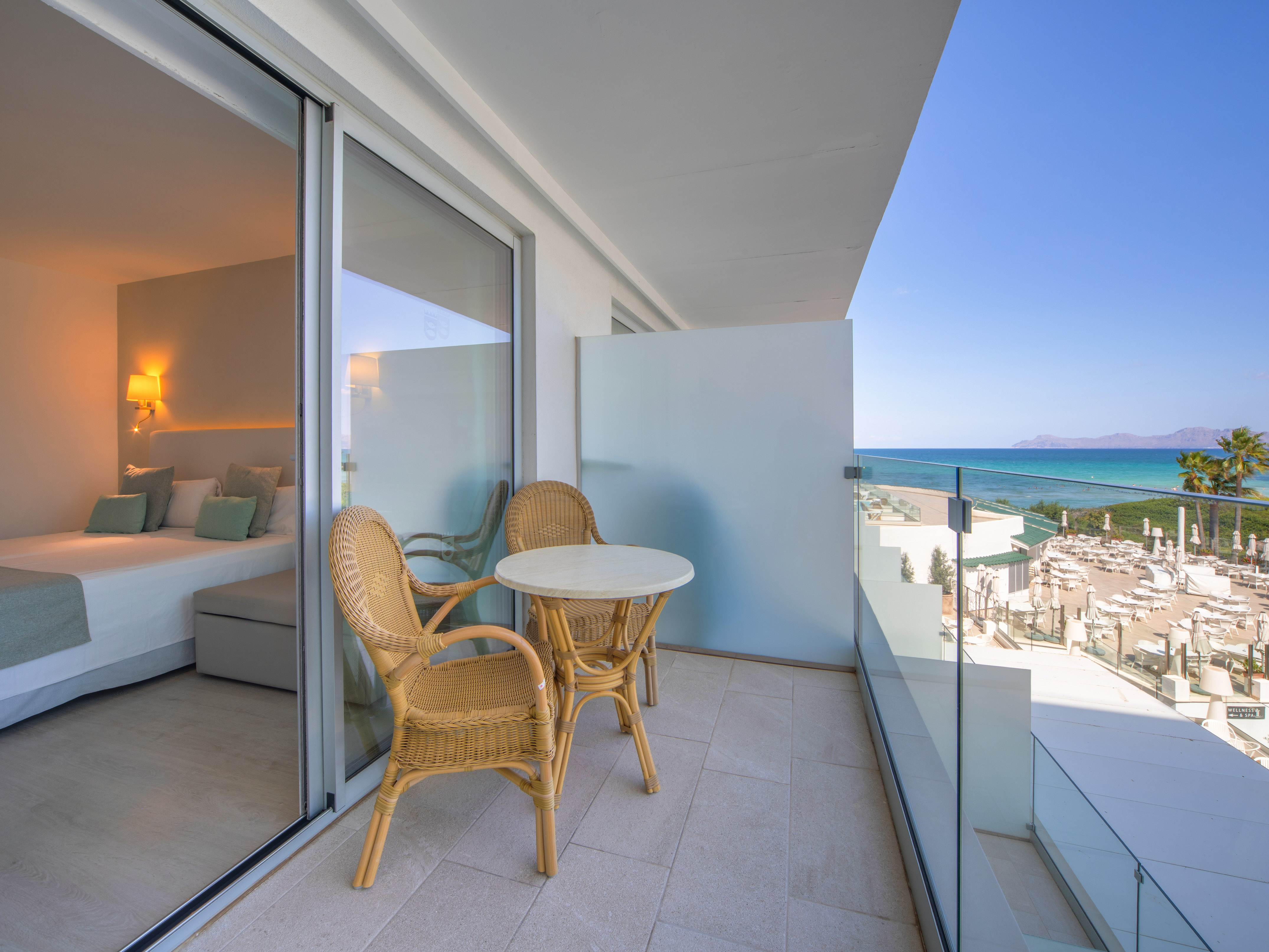 a balcony with chairs and a table