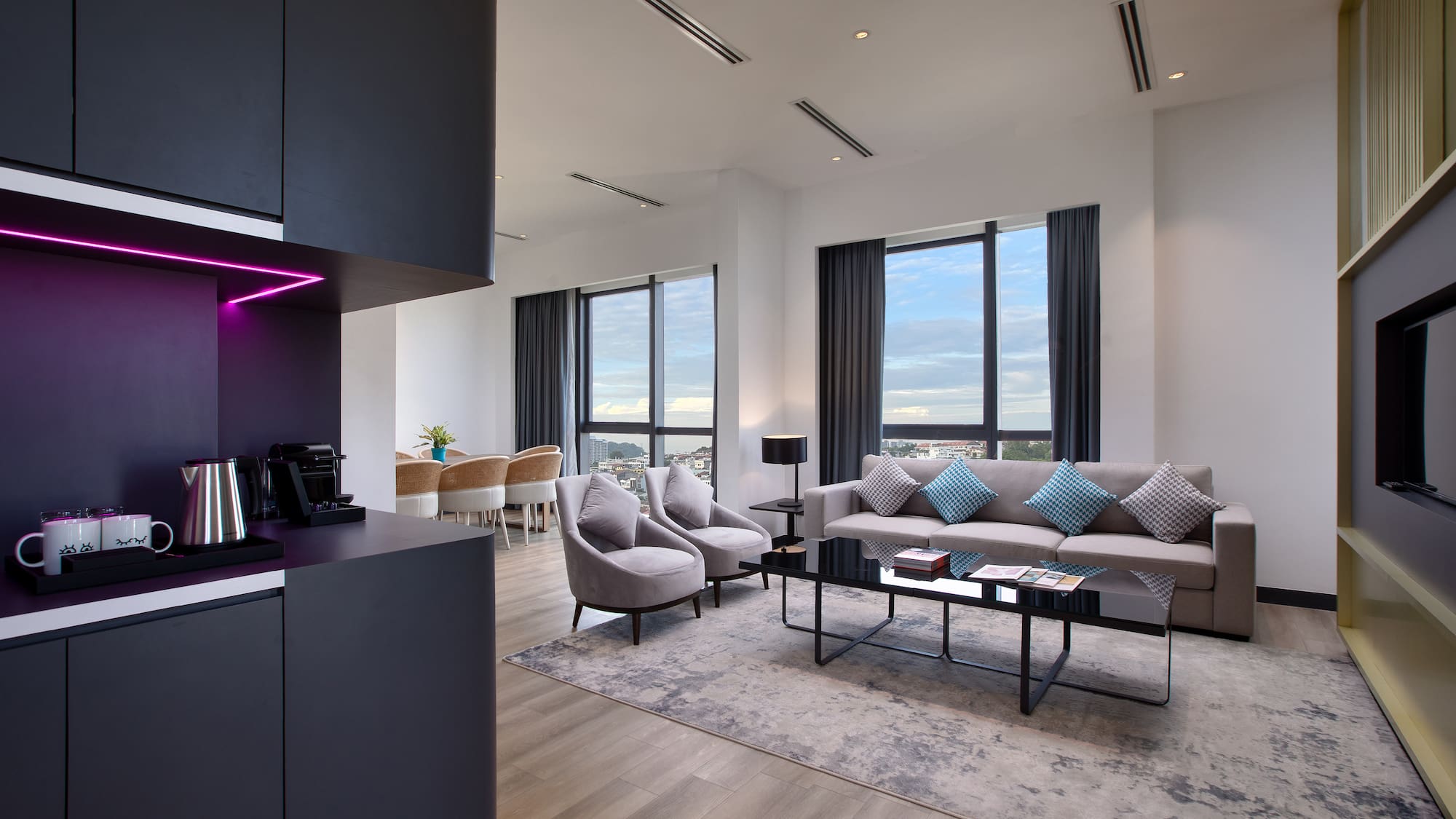 a room with a black counter top and a black cabinet and a couch and chairs
