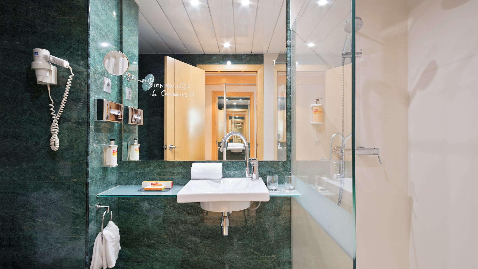 a bathroom with a glass shower door