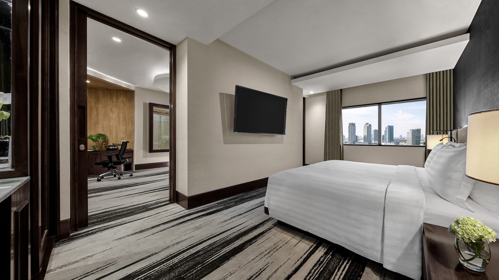a room with a bed and a television