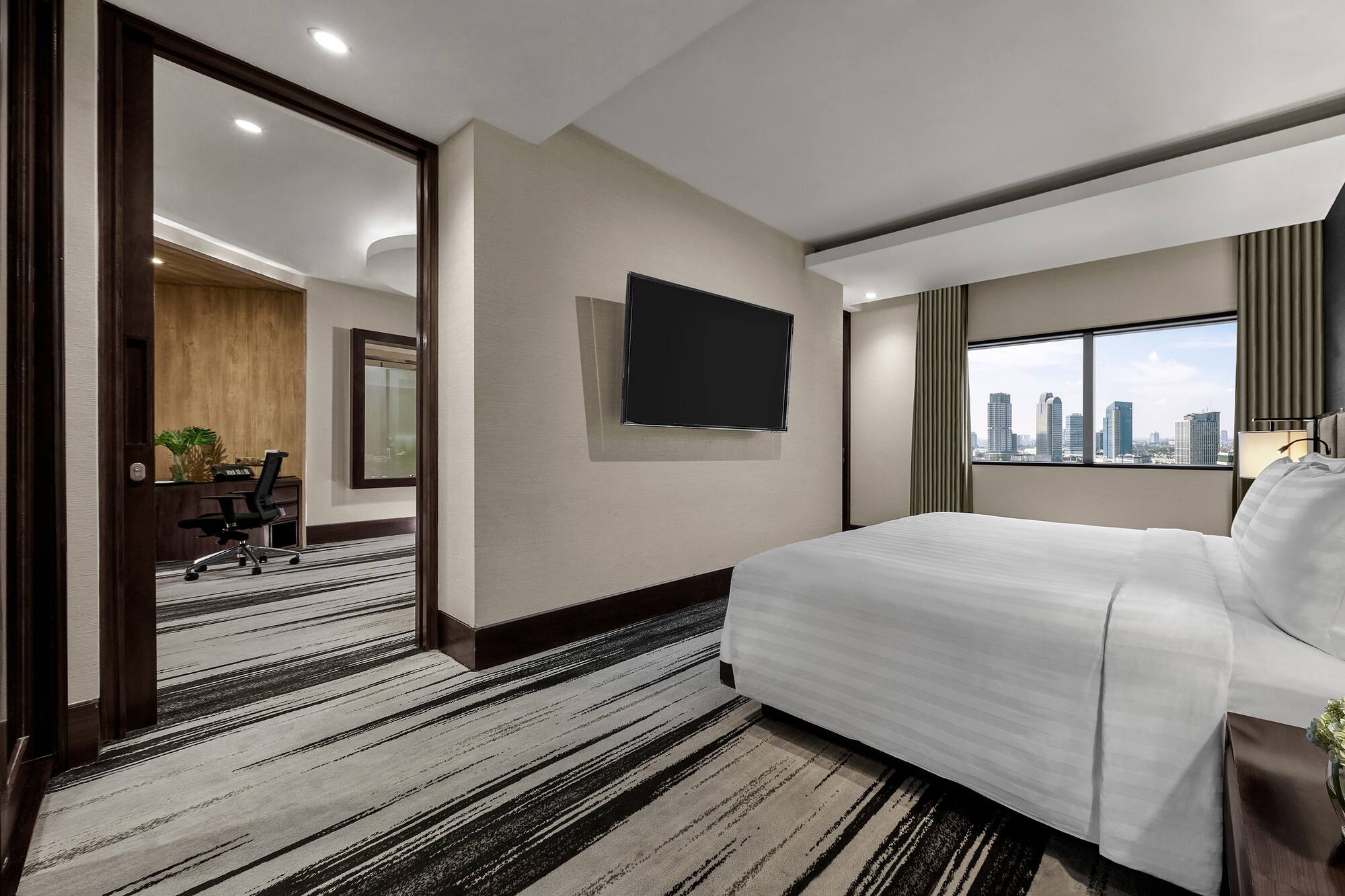 a room with a bed and a television