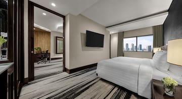 a room with a bed and a television