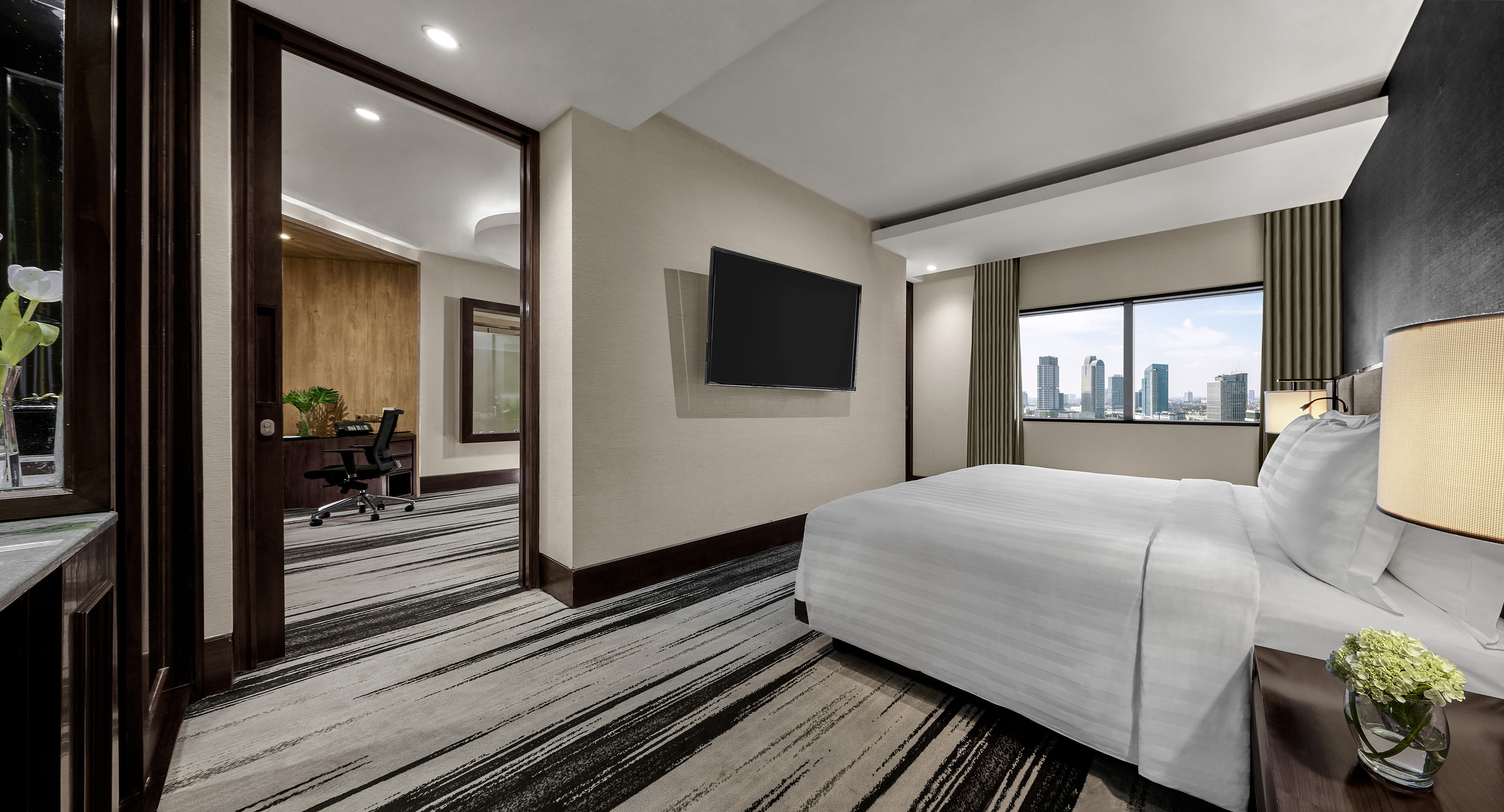 a room with a bed and a television