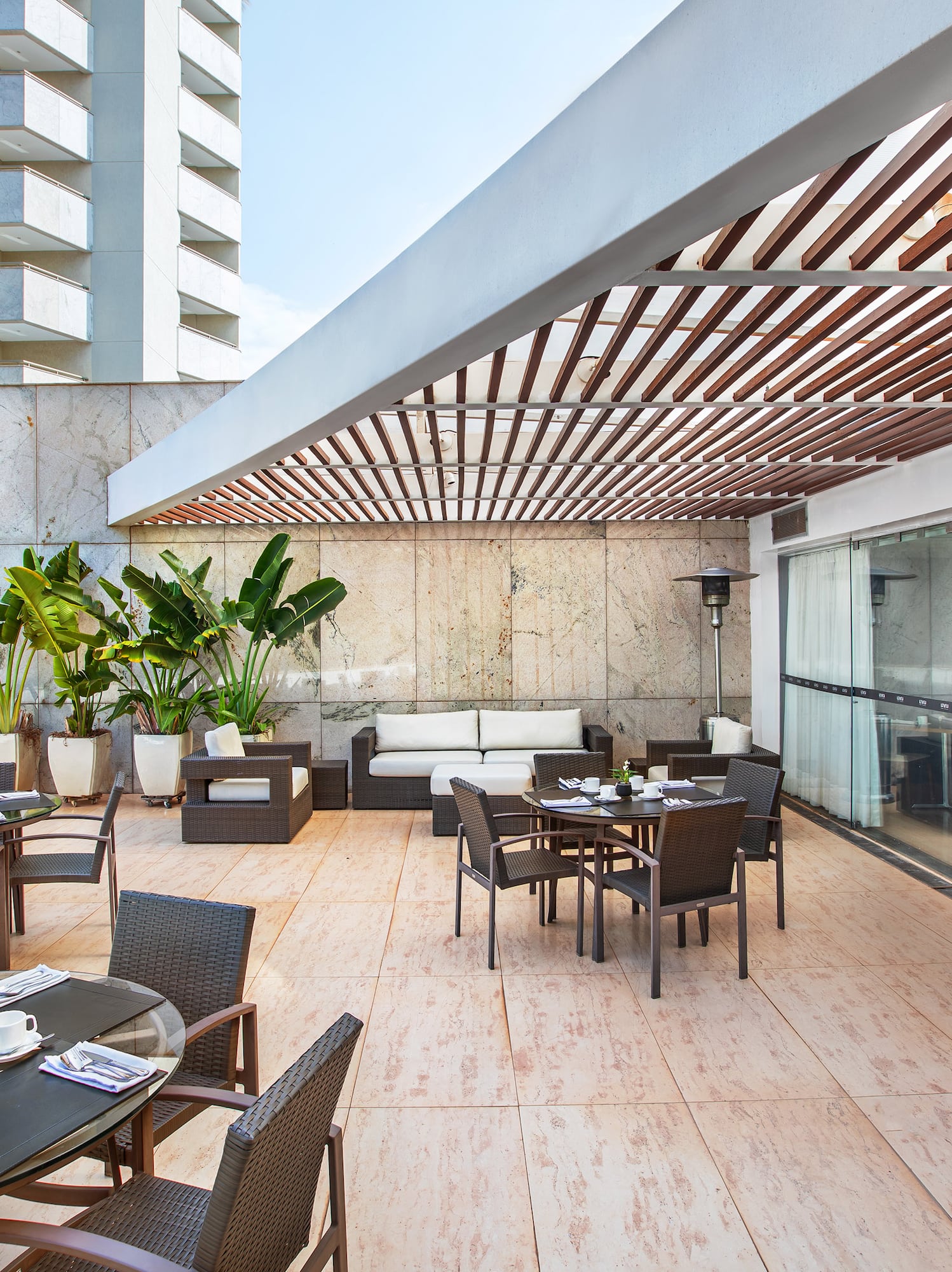 a patio with tables and chairs