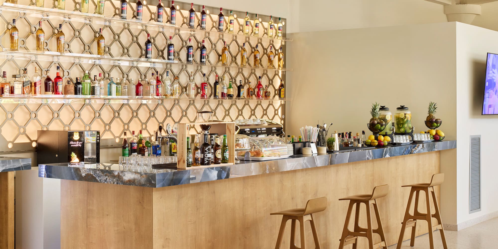 a bar with bottles of alcohol on the wall
