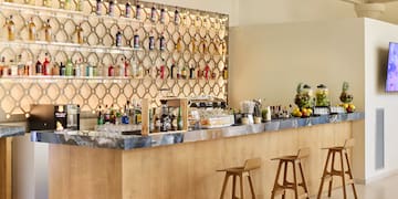 a bar with bottles of alcohol on the wall