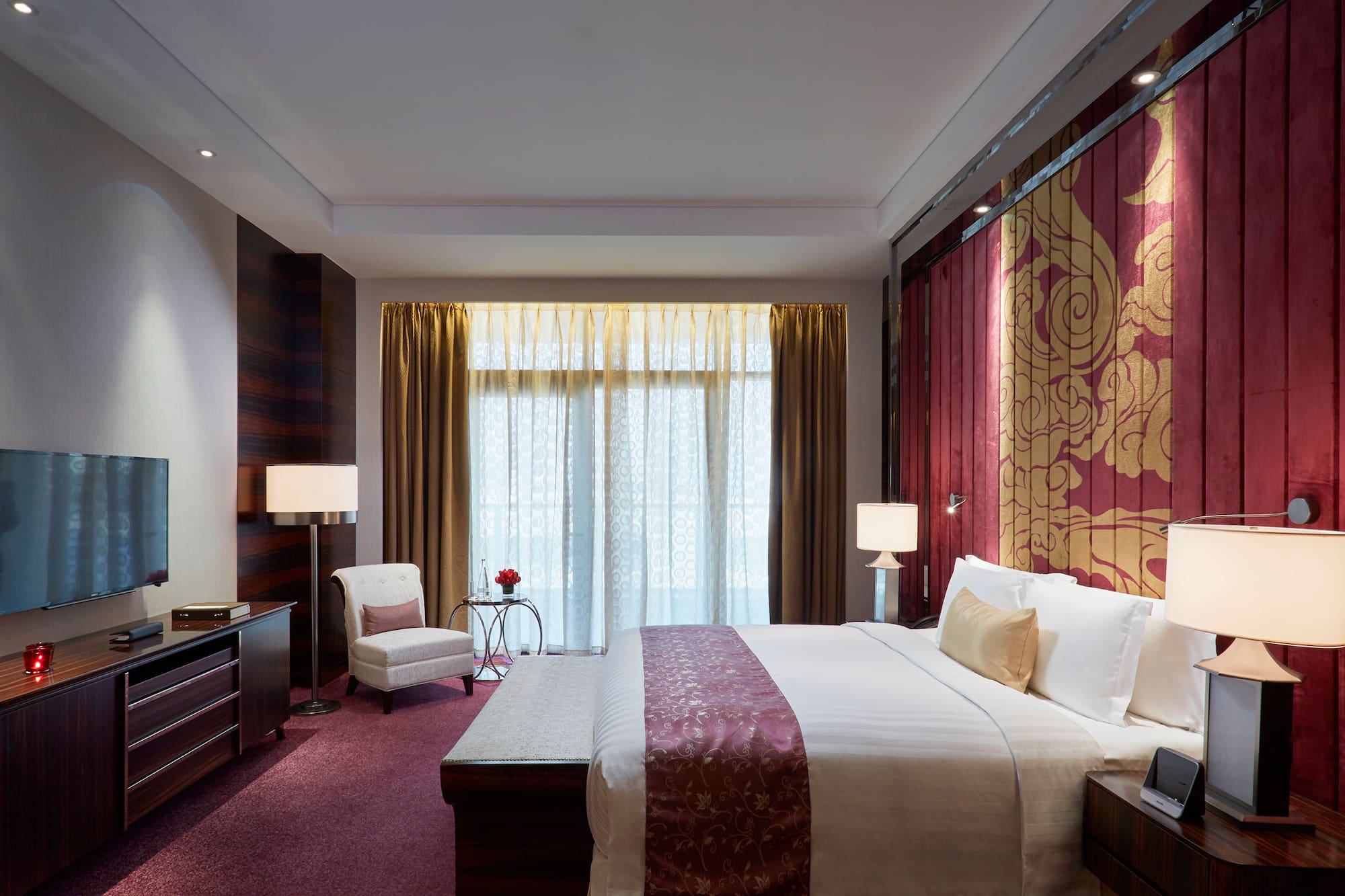 a bedroom with a bed and a chair