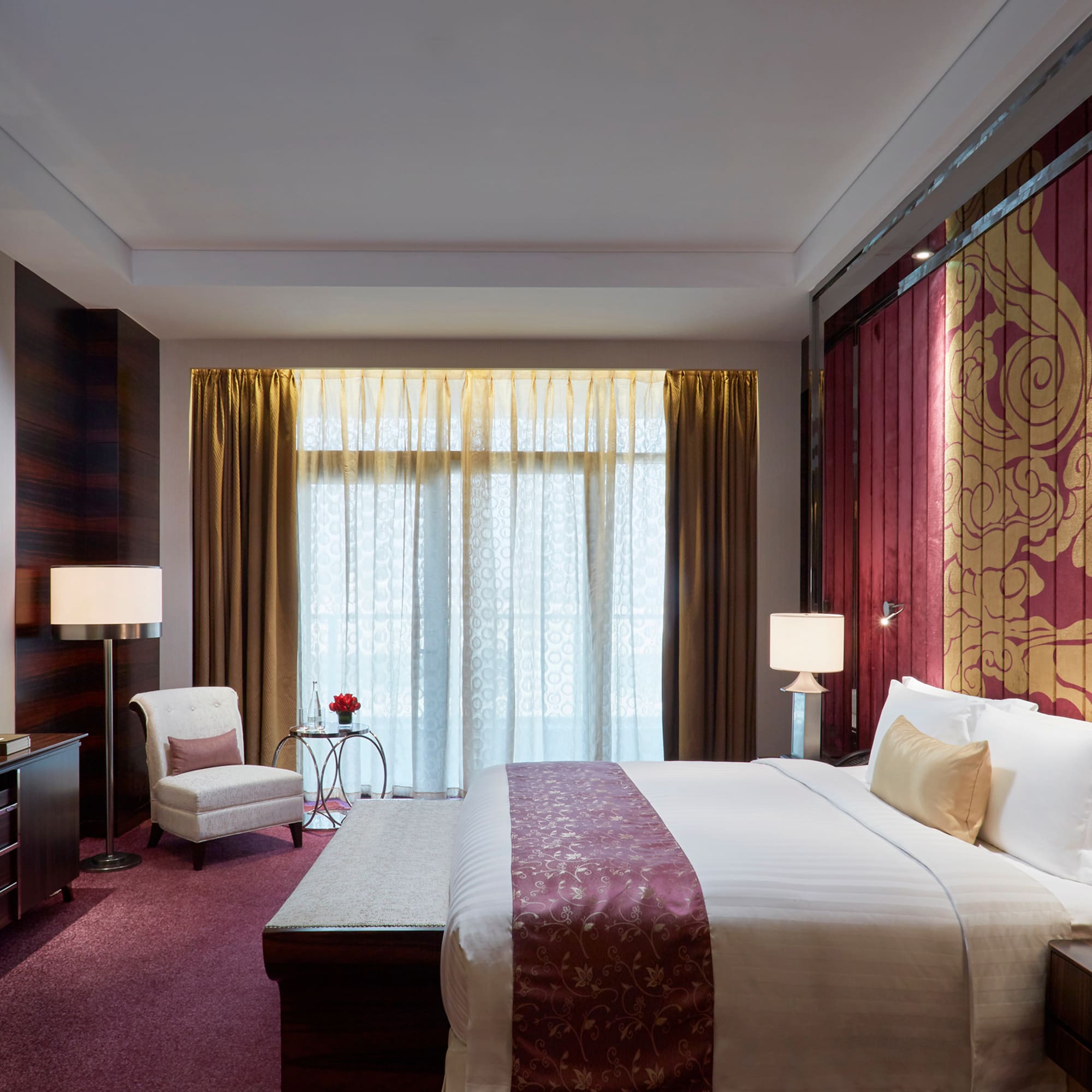 a bedroom with a bed and a chair