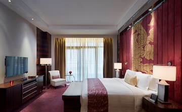 a bedroom with a bed and a chair